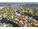 Expansive aerial view of a home with red outline on a waterfront lot with city views in the distance at 4811 Paradise S Way, St Petersburg, FL 33705