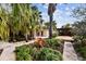 Charming backyard featuring lush tropical landscaping and a stylish pergola covered deck at 4811 Paradise S Way, St Petersburg, FL 33705