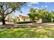 Beautiful single-story home featuring a red tile roof, well-maintained landscaping, and a fenced yard at 4811 Paradise S Way, St Petersburg, FL 33705