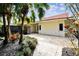 Private outdoor patio with stone pavers, lush greenery, and ample space for entertaining at 4811 Paradise S Way, St Petersburg, FL 33705