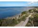 Expansive oceanfront view, showing a sandy shore, lush vegetation, and the endless blue ocean at 512 Oceanview Ave, Palm Harbor, FL 34683