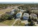 Aerial view of a charming white two-story home with lush landscaping and a convenient driveway at 512 Oceanview Ave, Palm Harbor, FL 34683