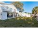 Backyard with a large porch, stairs, and a white fence at 512 Oceanview Ave, Palm Harbor, FL 34683