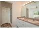 Bathroom with dual sinks, large mirror, and a shower stall at 512 Oceanview Ave, Palm Harbor, FL 34683