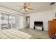 Bedroom with carpet, ceiling fan, closet and a sliding glass door leading to the patio at 512 Oceanview Ave, Palm Harbor, FL 34683