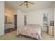 Bright bedroom features a ceiling fan, two windows, and an attached bathroom for added convenience at 512 Oceanview Ave, Palm Harbor, FL 34683