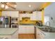 Kitchen featuring stainless steel appliances, white cabinets and plenty of counter space at 512 Oceanview Ave, Palm Harbor, FL 34683