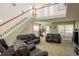 Bright living room with soaring ceilings, a staircase, and large windows at 512 Oceanview Ave, Palm Harbor, FL 34683