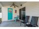 Covered patio with ceiling fan, multiple seating areas, and a blue accent door at 512 Oceanview Ave, Palm Harbor, FL 34683