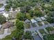 An aerial view of a house in a neighborhood surrounded by trees and other residential properties at 5504 60Th N Way, St Petersburg, FL 33709