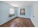 Cozy bedroom with light blue walls and a window providing natural light and a view of the backyard at 5504 60Th N Way, St Petersburg, FL 33709