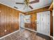 Entryway with wood paneling, white door, and tile flooring at 5504 60Th N Way, St Petersburg, FL 33709