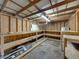 Unfinished garage with wooden beams, shelving, and ample workspace at 5504 60Th N Way, St Petersburg, FL 33709