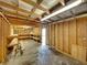 Spacious unfinished garage featuring exposed wooden beams, shelving, and a concrete floor at 5504 60Th N Way, St Petersburg, FL 33709