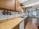 Well-lit kitchen featuring wood cabinets, white appliances, and a stainless steel sink at 5504 60Th N Way, St Petersburg, FL 33709