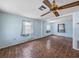 Spacious living room featuring light blue walls, tile flooring, and three windows at 5504 60Th N Way, St Petersburg, FL 33709