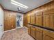 Room featuring wood paneling, tile floors, and wooden cabinets at 5504 60Th N Way, St Petersburg, FL 33709