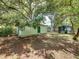 Exterior of a shed with green door surrounded by lush trees at 5504 60Th N Way, St Petersburg, FL 33709