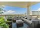 Spacious balcony featuring comfortable seating, plants, and scenic waterfront views on a sunny day at 5701 Mariner St # 606, Tampa, FL 33609