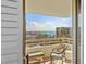 Balcony overlooks water views and city, enhanced by a chair and table, perfect for outdoor relaxation and entertaining at 5701 Mariner St # 606, Tampa, FL 33609