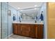 Elegant bathroom with a double vanity, large mirror, and a glass-enclosed shower at 5701 Mariner St # 606, Tampa, FL 33609