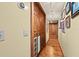 Hallway with hardwood floors and decorative framed pictures on the wall leading to the bedrooms at 5701 Mariner St # 606, Tampa, FL 33609