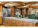 Kitchen island with marble countertop, stainless steel appliances, and natural wood cabinets at 5701 Mariner St # 606, Tampa, FL 33609