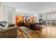 Sunlit main bedroom with hardwood floors, a seating area, and large windows with shutter blinds at 5701 Mariner St # 606, Tampa, FL 33609