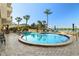 Resort-style pool with lounge chairs and umbrellas offering waterfront views at 5701 Mariner St # 606, Tampa, FL 33609