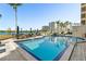 Outdoor pool with lounge chairs and umbrellas offering waterfront views at 5701 Mariner St # 606, Tampa, FL 33609