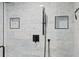 Updated tiled shower includes sleek, modern hardware and built-in storage shelves for a convenient and luxurious bathing experience at 5701 Mariner St # 606, Tampa, FL 33609