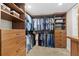 Well-organized walk-in closet with custom wood shelving and drawers for ample storage at 5701 Mariner St # 606, Tampa, FL 33609