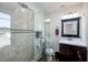 Updated bathroom featuring a tiled shower with glass door, modern vanity, and neutral color palette at 6342 5Th N Ave, St Petersburg, FL 33710