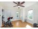 Bedroom featuring hardwood floors, ceiling fan, and bright windows, creating a comfortable living space at 6342 5Th N Ave, St Petersburg, FL 33710