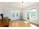 Sun-filled bedroom with gleaming hardwood floors, bright windows and detailed trim throughout the space at 6342 5Th N Ave, St Petersburg, FL 33710