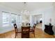 Bright dining room featuring a modern chandelier, hardwood floors, and ample natural light at 6342 5Th N Ave, St Petersburg, FL 33710