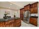 Kitchen includes stainless steel refrigerator, wood cabinets, and island with dark granite countertop at 6342 5Th N Ave, St Petersburg, FL 33710