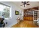 Inviting living room with large windows, wood floors, and built-in bookcase with decorative items at 6342 5Th N Ave, St Petersburg, FL 33710