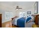 Bright bedroom with hardwood floors, ceiling fan, and natural light from three windows at 6342 5Th N Ave, St Petersburg, FL 33710