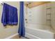 Clean bathroom features a shower-tub combination with a blue towel and curtain at 7510 Red Mill Cir, New Port Richey, FL 34653