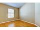 Bedroom featuring neutral walls, wood flooring, and a window at 7510 Red Mill Cir, New Port Richey, FL 34653