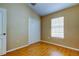 Bedroom featuring neutral walls, wood flooring, closet, and a window at 7510 Red Mill Cir, New Port Richey, FL 34653