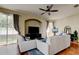 Cozy living room featuring hardwood floors, archway, and a comfortable seating arrangement with ample light at 7510 Red Mill Cir, New Port Richey, FL 34653