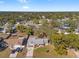 A beautiful aerial view of the home surrounded by mature trees in a quiet neighborhood at 8449 Valmora St, Spring Hill, FL 34608