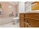 Classic bathroom with a shower, tub, and wooden vanity at 8449 Valmora St, Spring Hill, FL 34608