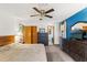 Comfortable bedroom featuring carpet floors, a ceiling fan, and an accent wall at 8449 Valmora St, Spring Hill, FL 34608