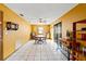 Open dining room with a ceiling fan, tile floors, and a wooden dining set at 8449 Valmora St, Spring Hill, FL 34608