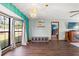 Living room featuring a large window, wood floors, and modern chandelier at 8449 Valmora St, Spring Hill, FL 34608