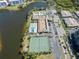 An aerial view of the complex showing the pool, tennis courts, parking, and adjacent buildings at 9950 62Nd N Ter # 203, St Petersburg, FL 33708