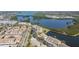 An aerial view of the neighborhood showcasing the beautiful lake and lush green landscape surrounding the homes at 9950 62Nd N Ter # 203, St Petersburg, FL 33708